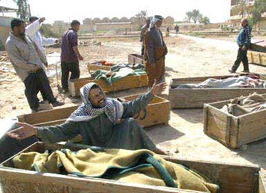 April 1st.  The Massacre at Hilla near Babylon. An Iraqi man grieves over the body of his mother.