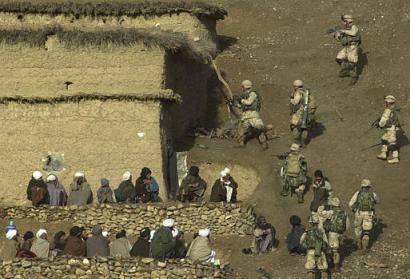 Soldiers of the 82nd Airborne search a house in a village of the Baghran valley on February 24, 2003 [AP photo/Aaron Favila]